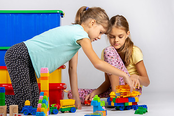 Image showing Two girls collect figures from the designer