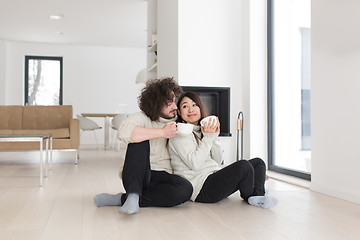 Image showing happy multiethnic couple  in front of fireplace