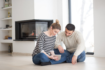 Image showing Young Couple using digital tablet on cold winter day