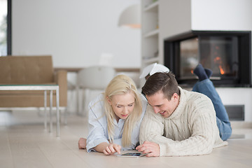 Image showing Young Couple using digital tablet on cold winter day