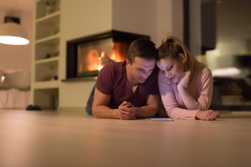 Image showing Young Couple using digital tablet on cold winter night