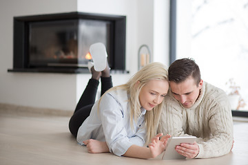 Image showing Young Couple using digital tablet on cold winter day