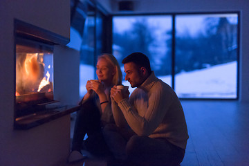 Image showing happy couple in front of fireplace