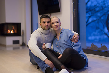 Image showing happy couple in front of fireplace