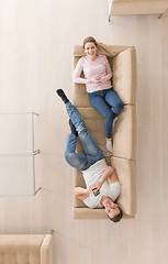 Image showing Young couple on the sofa watching television top view