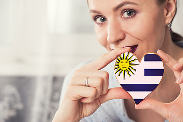 Image showing Young woman with gingerbread heart cookies with flag