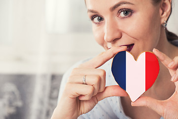 Image showing Young woman with gingerbread heart cookies with flag