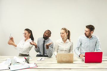 Image showing Young men and women sitting at office and working on laptops. Emotions concept