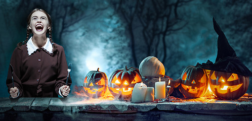 Image showing Bloody Halloween theme: crazy girl with a knife