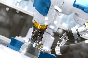 Image showing Automatic robot arm working in industrial environment