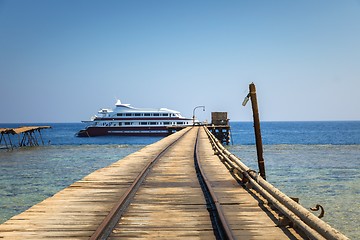 Image showing Long wooden piel leading into the sea