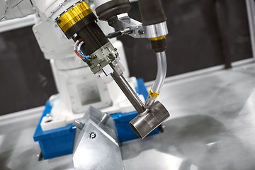 Image showing Automatic robot arm working in industrial environment