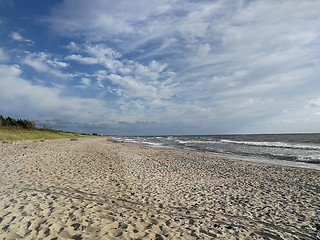 Image showing Wild sandy beach under cloudy sky of sunset