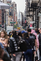 Image showing New York, NY, USA - May 17, 2018: Crowds of people walking sidewalk of Broadway avenue in Soho of Midtown Manhattan on may 17th, 2018 in New York City, USA.