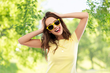 Image showing teenage girl in yellow sunglasses and t-shirt