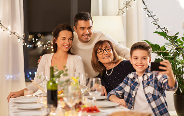 Image showing family having dinner party and taking selfie