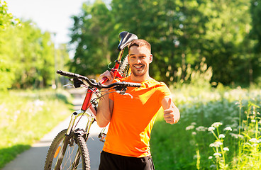 Image showing happy man with bicycle showing thumbs up in summer