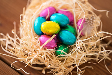 Image showing chocolate easter eggs in straw nest on table