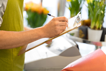 Image showing florist man with clipboard at flower shop