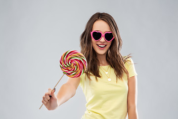 Image showing teenage girl in sunglasses with lollipop