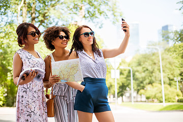 Image showing women with city guide and map taking selfie