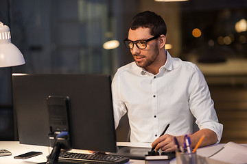 Image showing designer with computer and pen tablet at office