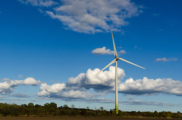 Image showing Windmill by a blue sky with white clouds by fall season