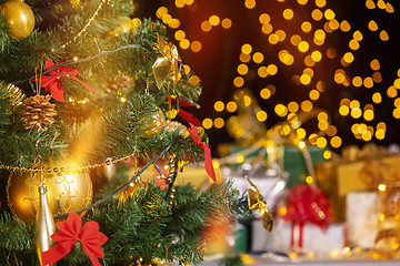 Image showing Christmas presents and candles under Christmas tree