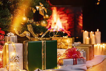 Image showing Christmas presents and candles under Christmas tree