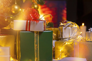 Image showing Christmas presents and candles under Christmas tree