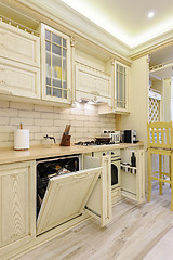 Image showing Luxury modern beige kitchen closeup, some drawers open