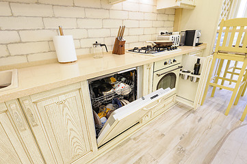 Image showing Luxury modern beige kitchen closeup, some drawers open