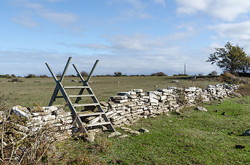 Image showing Wooden stile crossing an old dry stone wall