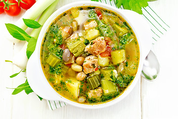 Image showing Soup with pisto sauce in bowl on board top