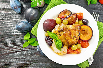 Image showing Chicken with fruits and tomatoes in plate on board top