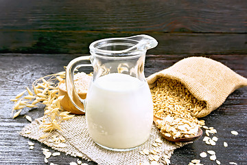 Image showing Milk oatmeal in jug on napkin