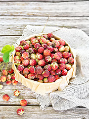Image showing Strawberries in box on wooden old board
