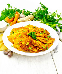 Image showing Pancakes of pumpkin with cheese in white plate on wooden board