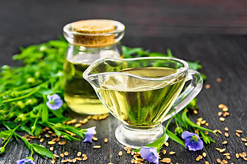 Image showing Oil flaxseed in gravy boat and jar on board