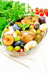 Image showing Chicken with fruits and tomatoes in pan on light board