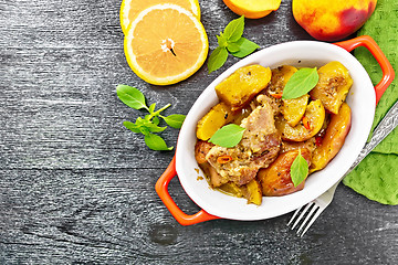 Image showing Turkey with peaches in pan on dark board top