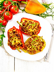 Image showing Pepper stuffed with meat and couscous in plate on board top