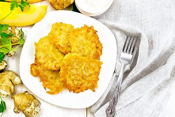 Image showing Pancakes of pumpkin with Jerusalem artichoke on light board top