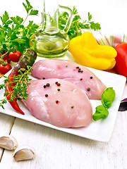 Image showing Chicken breast raw in plate on light board