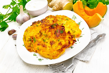 Image showing Pancakes of pumpkin in plate on light wooden board