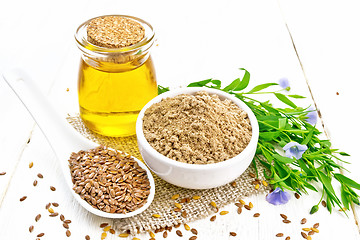 Image showing Flour linen in bowl with seeds and oil on board