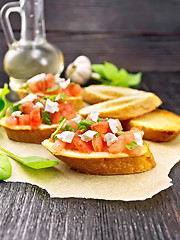 Image showing Bruschetta with tomato and cheese on parchment