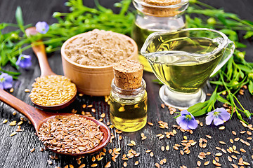 Image showing Oil flaxseed with flour and seeds on dark board