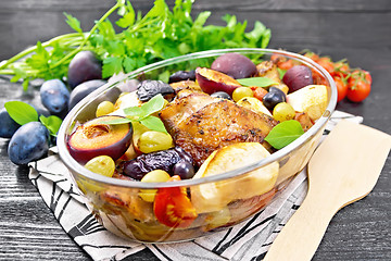 Image showing Chicken with fruits and tomatoes in glass pan on board