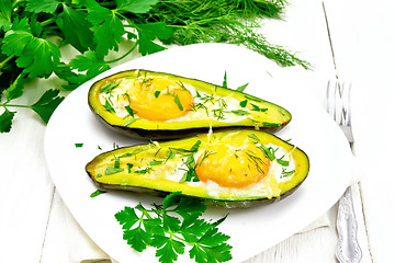 Image showing Scrambled eggs in avocado on wooden board